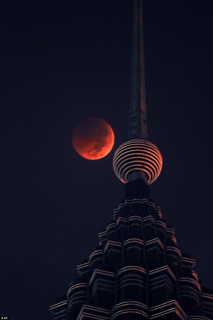 Tại tòa tháp đôi Petronas ở Malaysia vào rạng sáng nay, "trăng máu" xuất hiện mang tới khung cảnh vô cùng đẹp. (Ảnh: AP)